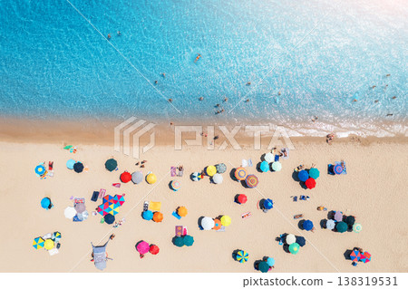 Aerial view of colorful umbrellas on sandy beach, blue sea 138319531
