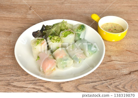 steamed Thai large rice noodles salad roll stuffed shrimp and salmon couple tuna on plate dipping spicy chili cheese sauce steamed Thai large rice noodles salad roll stuffed shrimp and salmon couple tuna on plate dipping spicy chili cheese sauce 138319870