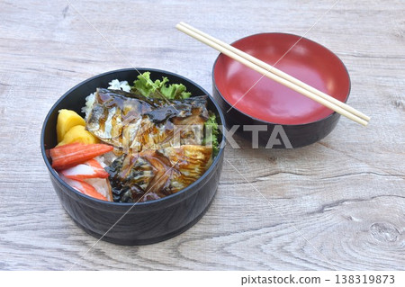 grilled saba fish or mackerel on rice topping sweet egg and crab stick couple lettuce salad bento set in lunch box grilled saba fish or mackerel on rice topping sweet egg and crab stick couple lettuce salad bento set in lunch box 138319873