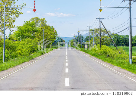 Summer in Hokkaido: A long road stretching as far as the eye can see (image) 138319902