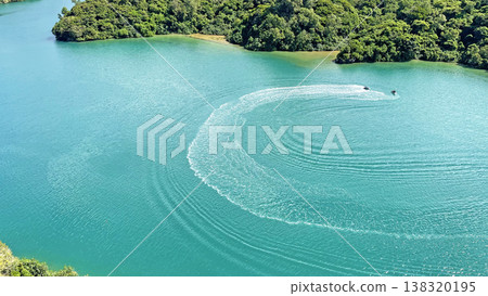 A magnificent view from Warumi Bridge: Emerald green sea and white wakes left by jet skis. Nakijin Village, Okinawa Prefecture. A magnificent view from Warumi Bridge: Emerald green sea and white wakes left by jet skis. Nakijin Village, Okinawa Prefecture. 138320195