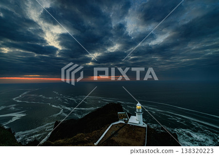 The scene of the lighthouse standing amidst heavy clouds and a calm sea before dawn at Cape Chikyu. The scene of the lighthouse standing amidst heavy clouds and a calm sea before dawn at Cape Chikyu. 138320223