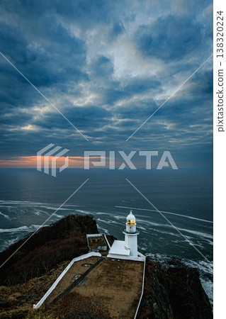 Cape Chikyu before dawn: The lighthouse light and the expansive clouds create a fantastical scene over the sea. Cape Chikyu before dawn: The lighthouse light and the expansive clouds create a fantastical scene over the sea. 138320224