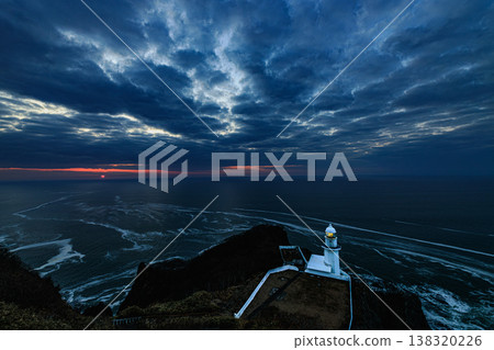 The seascape of Muroran, Hokkaido, enveloped in the light of the lighthouse and silence before dawn at Cape Chikyu. The seascape of Muroran, Hokkaido, enveloped in the light of the lighthouse and silence before dawn at Cape Chikyu. 138320226