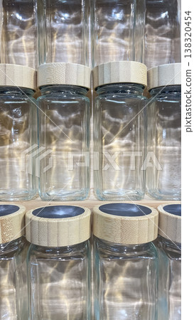 Minimalist glass spice jars with bamboo lids and chalkboard tops for organized eco friendly kitchen 138320454