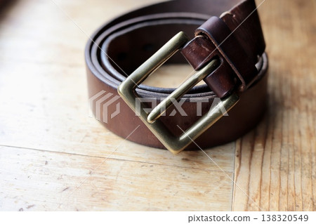 Worn brown leather belt 138320549