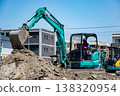 A worker using a small excavator to develop a residential area 138320954