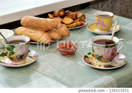 A few cups of tea, bread and butter. 138321031