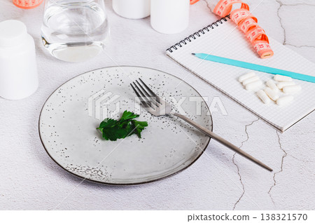 Concept of hunger, diet, weight loss and vegetarianism on an empty plate on the table 138321570