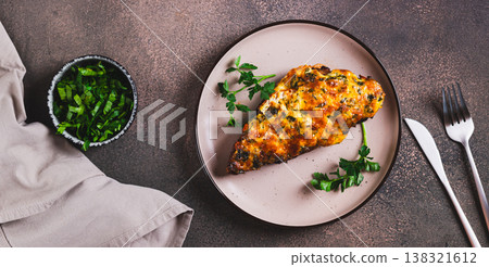 Appetizing meat baked under a cheese crust on a plate on the table top view web banner 138321612