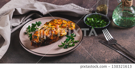 Pork loin baked with cheese, tomatoes and mushrooms on a plate on the table web banner Pork loin baked with cheese, tomatoes and mushrooms on a plate on the table web banner 138321613