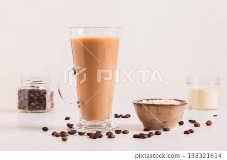 Protein coffee in a glass and protein powder in a bowl on the table Protein coffee in a glass and protein powder in a bowl on the table 138321614