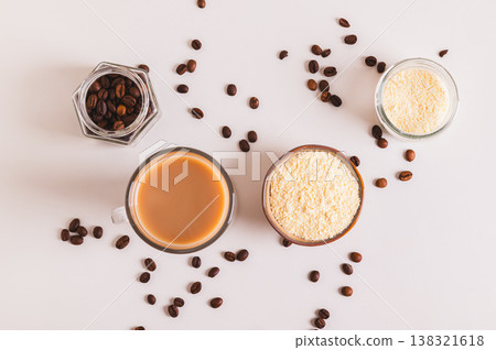 Protein coffee in a glass and protein powder in a bowl on the table top view Protein coffee in a glass and protein powder in a bowl on the table top view 138321618