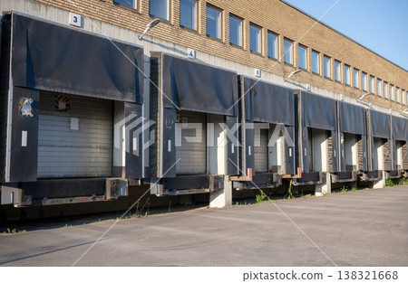 Industrial warehouse loading docks with truck bays logistics distribution center exterior commercial building Industrial warehouse loading docks with truck bays logistics distribution center exterior commercial building 138321668