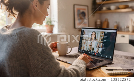 Candid documentary of a diverse man having a video conference on a laptop at home in natural light, capturing a real life morning routine, remote work lifestyle, and everyday work life balance 138322872