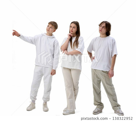 Teenagers looking and pointing upward curious reaction isolated white background 138322952