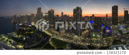 Aerial view of downtown office district of of Miami Brickell in Florida, USA at night. High commercial and residential skyscraper buildings in modern american megapolis Aerial view of downtown office district of of Miami Brickell in Florida, USA at night. High commercial and residential skyscraper buildings in modern american megapolis 138323170