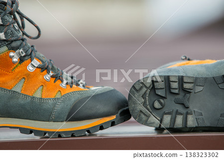 A pair of leather trekking hiking winter boots on blurred background 138323302