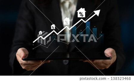 Business growth analysis concept with graph, house icons, and digital tablet reflecting increasing values in real estate market trends and investments Gantry Business growth analysis concept with graph, house icons, and digital tablet reflecting increasing values in real estate market trends and investments Gantry 138323468