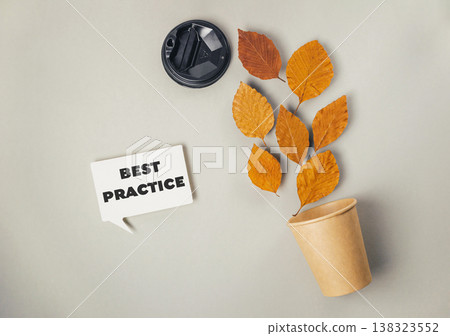 Creative composition featuring autumn leaves emerging from a paper cup beside a coffee lid, symbolizing sustainability and best practices in environmental awareness Creative composition featuring autumn leaves emerging from a paper cup beside a coffee lid, symbolizing sustainability and best practices in environmental awareness 138323552