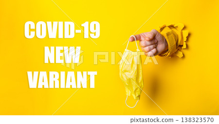 Hand holding yellow face mask emerging from torn yellow background, symbolizing health awareness and the emergence of new COVID-19 variant in a vibrant and impactful visual concept Hand holding yellow face mask emerging from torn yellow background, symbolizing health awareness and the emergence of new COVID-19 variant in a vibrant and impactful visual concept 138323570