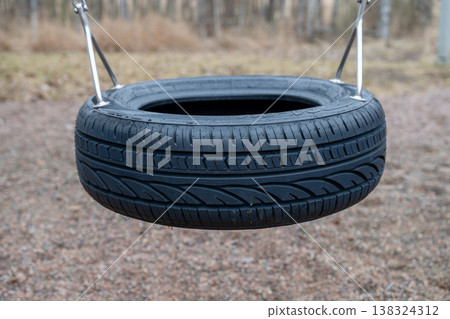 Tire swing in playground outdoor leisure activity childhood recreation concept 138324312