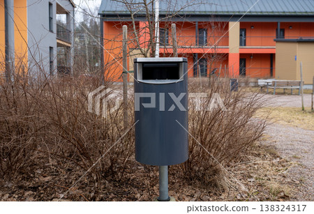 Modern outdoor trash bin in residential yard urban environment minimal waste management concept Modern outdoor trash bin in residential yard urban environment minimal waste management concept 138324317