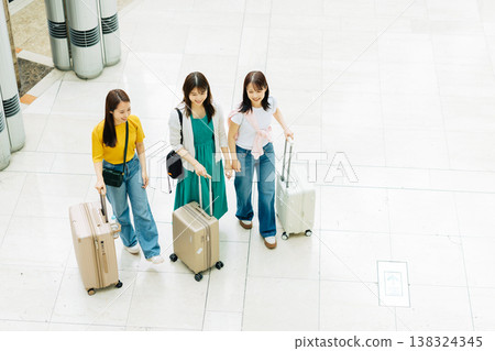 Three women at the airport setting off on a trip (Photography cooperation: Kansai International Airport (KIX)) 138324345