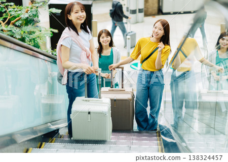 Three women riding an escalator at the airport. (Photo courtesy of Kansai International Airport (KIX)) Three women riding an escalator at the airport. (Photo courtesy of Kansai International Airport (KIX)) 138324457