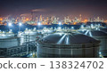 Night View of a Vast Oil Refinery with Docked Ships 138324702