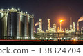 Night View of a Vast Oil Refinery with Docked Ships 138324704
