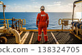 Worker on offshore oil platform gazes at the vast ocean 138324705