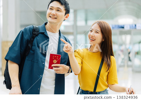 A couple holding passports at the airport. (Photo courtesy of Kansai International Airport (KIX)) 138324936