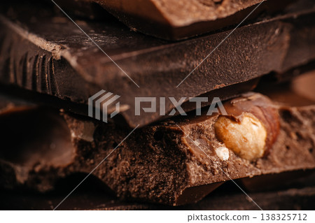 Stacked chocolate bars with hazelnut closeup Stacked chocolate bars with hazelnut closeup 138325712