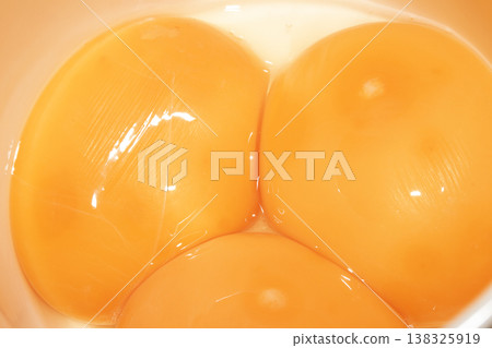 Abstract close up of golden yellow egg yolks close together Abstract close up of golden yellow egg yolks close together 138325919