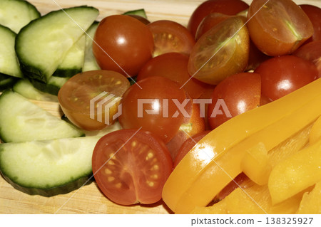 Close up of chopped chili salad vegetables on a wooden chopping board Close up of chopped chili salad vegetables on a wooden chopping board 138325927
