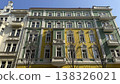 Colorful buildings line the street in Prague under a clear blue sky during daytime 138326021
