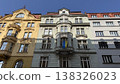 Old buildings stand side by side on a street in Prague with clear blue skies above during the day 138326023