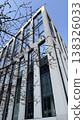 Modern building framed by tree branches in Prague on a clear day during autumn 138326033