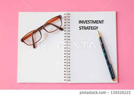INVESTMENT STRATEGY words in the notebook.Economic Money Concept. INVESTMENT STRATEGY words in the notebook.Economic Money Concept. 138326222