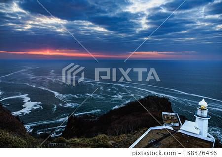 Sunrise at Cape Chikyu in Muroran: The contrast between rough waves, the rising sun, and the lighthouse. Sunrise at Cape Chikyu in Muroran: The contrast between rough waves, the rising sun, and the lighthouse. 138326436