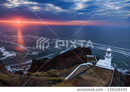 Sunrise at Cape Chikyu: A breathtaking view of the sea and lighthouse illuminated by the rising sun. 138326439