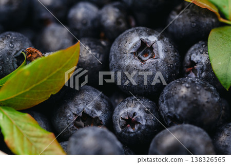 Antioxidants and vitamins. Fresh blueberry with leaves macro photography shot, food background Antioxidants and vitamins. Fresh blueberry with leaves macro photography shot, food background 138326565