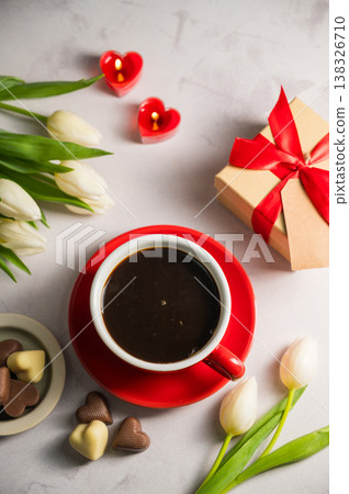 Valentine's day. Cup of coffee, heart chocolates, gift box, heart candles and spring white tulip flower bouquet. Mother's day 138326710