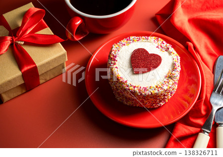Valentine's Day, Love festive red background with gift box. Cake with red heart and cup of coffee. 138326711