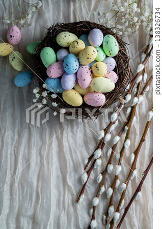 Easter mini decorative eegs in a nest with willow twigs, bright background Easter mini decorative eegs in a nest with willow twigs, bright background 138326734