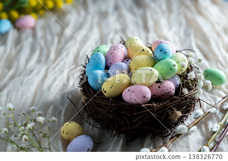 Easter mini decorative eegs in a nest with willow twigs, bright background Easter mini decorative eegs in a nest with willow twigs, bright background 138326770