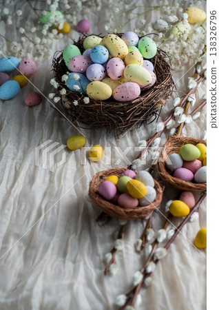 Easter mini decorative eegs in a nest with willow twigs, bright background Easter mini decorative eegs in a nest with willow twigs, bright background 138326796