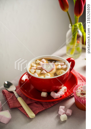 Valentine's Day background. Red cup of coffee with heart shaped marshmallows and ret tulips 138326809