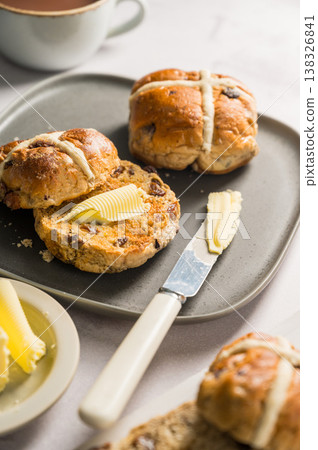 Cross Buns with butter in a plate. Breakfast concept. Close up shot. Easter treat buns Cross Buns with butter in a plate. Breakfast concept. Close up shot. Easter treat buns 138326841